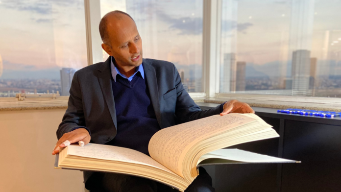 Wandemberg Marques mostrando a Bíblia manuscrita que escreveu à mão durante projeto de transcrição completa das Escrituras.